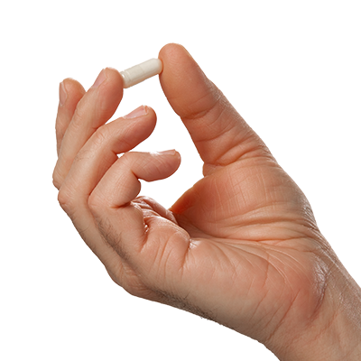 Hand holding a single off-white Vital Vitamins Multi-Collagen Complex Plus capsule against a plain black background